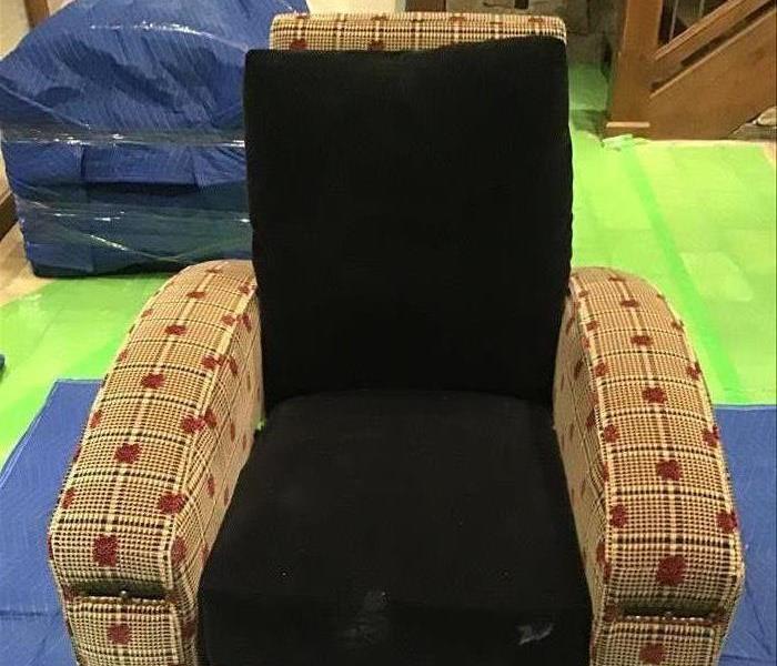 Cloth chair with black cushions. 
