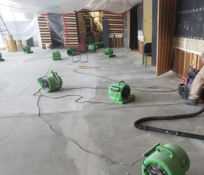 Garage floor covered in green air movers. 