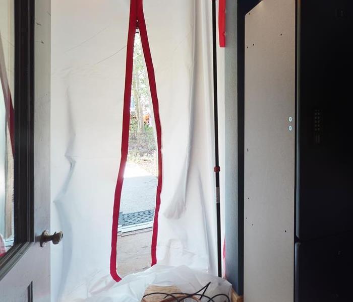 White sheet with red tape securing an area.