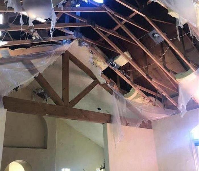 Ceiling has fallen showing the bare beams. 